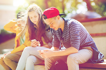 Image showing happy teenage friends with smartphones outdoors