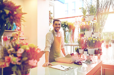 Image showing florist man with clipboard at flower shop counter