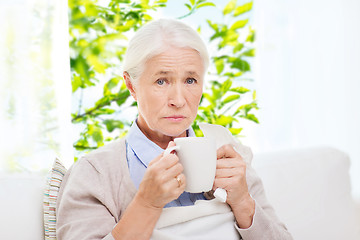 Image showing sick senior woman drinking hot tea at home