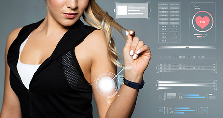 Image showing close up of sporty woman with fitness tracker