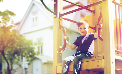 Image showing happy boy on children playground climbing frame