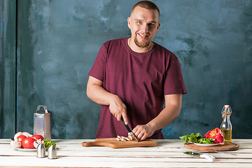 Image showing Closeup hand of chef baker making pizza at kitchen