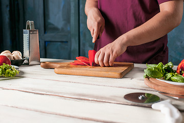 Image showing Closeup hand of chef baker making pizza at kitchen