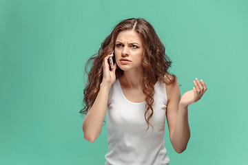 Image showing The portrait of disgusted woman with mobile phone