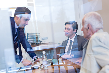 Image showing Business people sitting and brainstorming at corporate meeting.