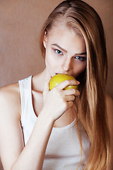 Image showing young pretty blond woman with green apple happy cheerful smiling