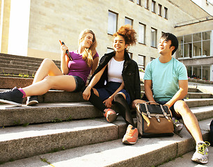 Image showing cute group of teenages at the building of university with books 