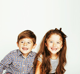 Image showing little cute boy and girl hugging playing on white background, ha