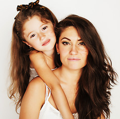 Image showing young mother with little cute daughter emotional posing on white