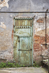 Image showing grunge metal door, cracked brick wall