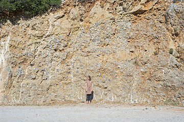 Image showing Young woman standing near the mountain slope