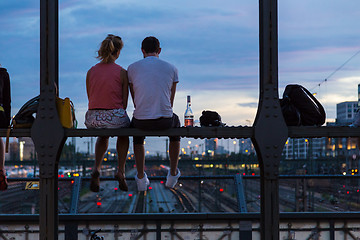 Image showing Young couple on romantic date on urban railway bridge, Munich, Germany.