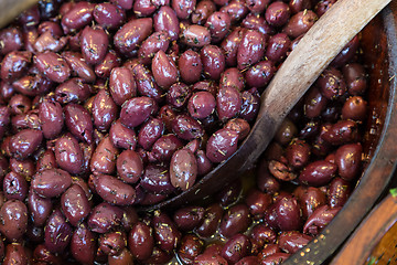 Image showing Olives in wooden bowls with serving spoon.