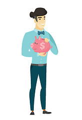 Image showing Asian business man holding a piggy bank.