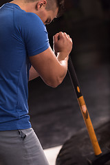 Image showing man workout with hammer and tractor tire