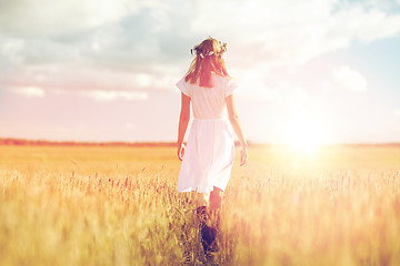 Image showing happy young woman in flower wreath on cereal field