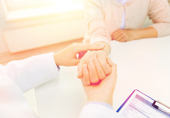 Image showing doctor checking senior woman pulse at hospital