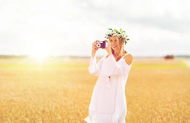 Image showing happy woman with film camera in wreath of flowers