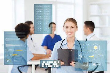 Image showing happy doctor with clipboard at hospital