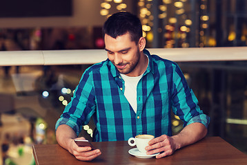 Image showing happy man with smartphone and coffee at restaurant