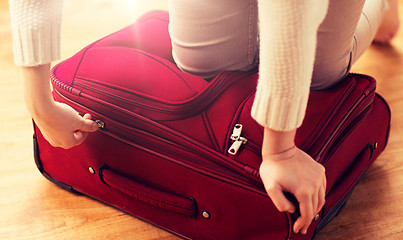 Image showing close up of woman packing travel bag for vacation