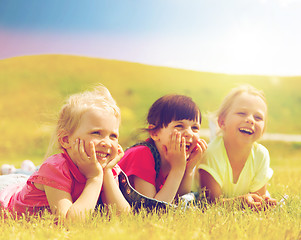 Image showing group of kids lying on blanket or cover outdoors