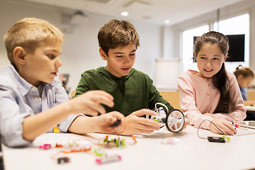 Image showing happy children building robots at robotics school