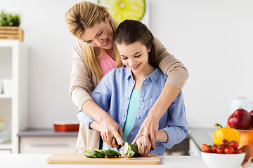 Image showing happy family cooking dinner at home kitchen