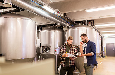 Image showing men working at craft brewery or beer plant