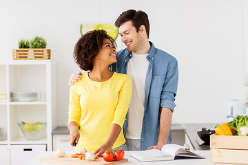 Image showing happy couple cooking food at home kitchen