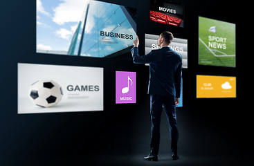 Image showing businessman working with virtual applications