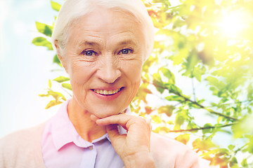 Image showing happy senior woman over green natural background