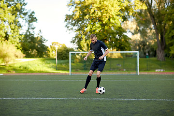 Image showing soccer player playing with ball on football field