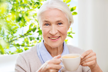 Image showing happy senior woman with cup of coffee