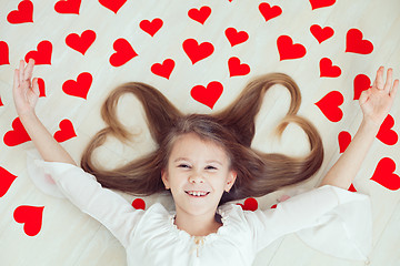 Image showing One little girl lying on the floor.