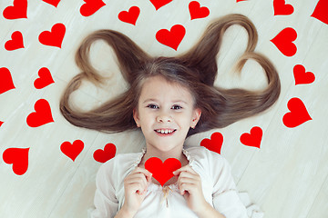 Image showing One little girl lying on the floor.