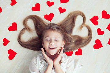 Image showing One little girl lying on the floor.