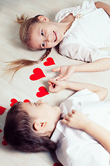 Image showing little boy and girl lying on the floor.