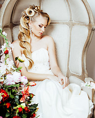 Image showing beauty young blond woman bride alone in luxury vintage interior with a lot of flowers 