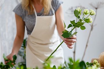 Image showing Young girl florist with flowers