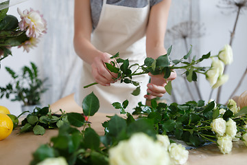 Image showing Young florist woman with roses