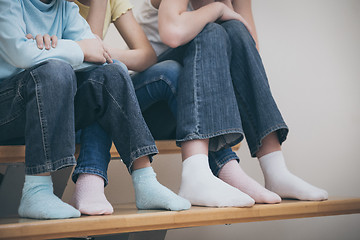 Image showing happy children which are sitting on the stairs in the house.