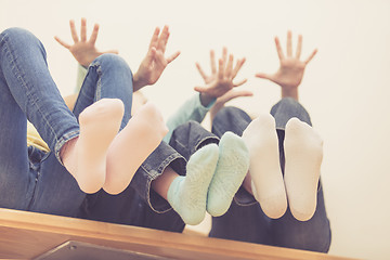 Image showing happy children which are sitting on the stairs in the house.