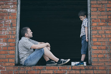 Image showing Portrait of sad little boy and father.