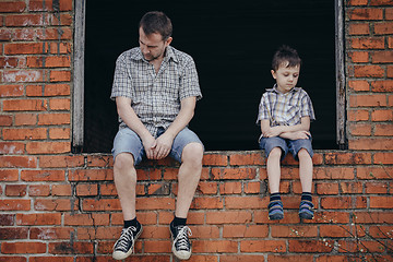 Image showing Portrait of sad little boy and father.