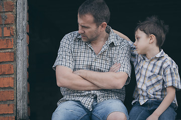 Image showing Portrait of sad little boy and father.