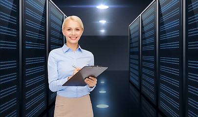 Image showing businessman with clipboard over server room