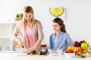 Image showing happy family cooking dinner at home kitchen