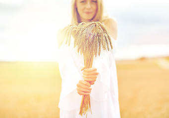 Image showing close up of happy woman with cereal spikelets