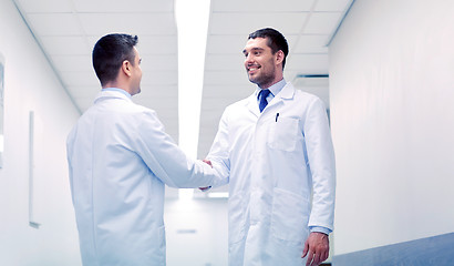 Image showing smiling doctors at hospital doing handshake